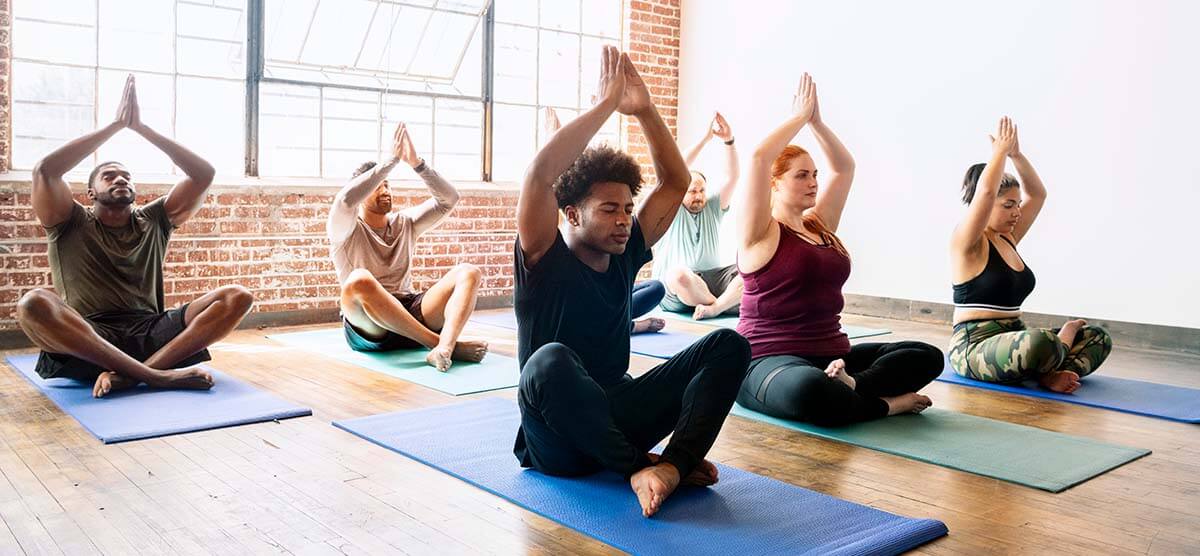 Diverse people doing yoga poses
